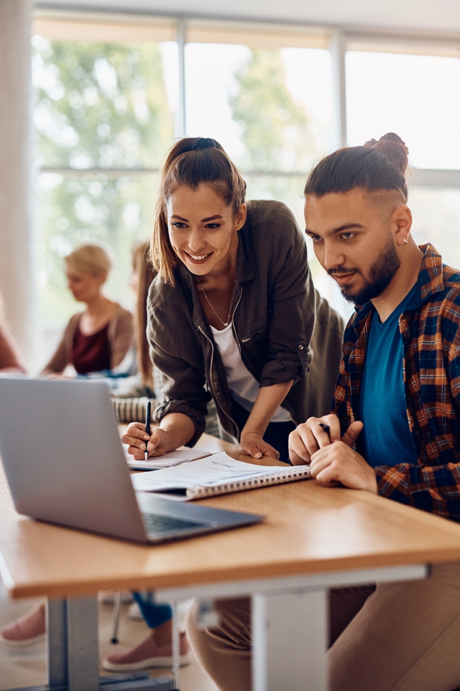 Happy,University,Student,Taking,Notes,While,Studying,On,Laptop,With