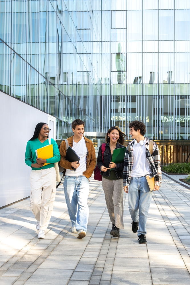 Vertical,Image,Of,Multiracial,Happy,University,Students,Walking,To,Class